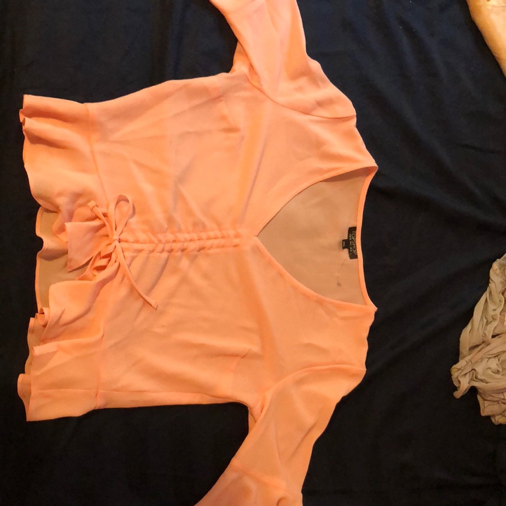 Light pink ruffle front tie blouse